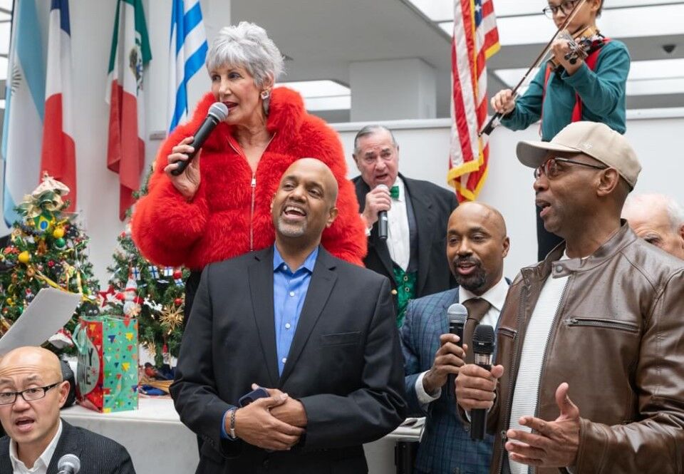 Cook County Treasurer Maria Pappas is hosting her annual holiday party on Fri., Dec. 6 at her office, 118 N. Clark. All are welcome! (Pappas shown in this photo with Pastor John Harrell, 2nd from R, founder of Black Men United.) (Photo by Candace Jordan)